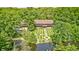 Gorgeous home exterior featuring a sprawling lawn with manicured gardens and mature trees near a pond at 9600 N 500 E, Pendleton, IN 46064