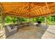 Inviting gazebo interior with wicker furniture and natural wood beam ceiling, creating a cozy outdoor living space at 9600 N 500 E, Pendleton, IN 46064