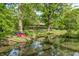 Scenic view of home from across the pond, enhanced by trees and nature at 9600 N 500 E, Pendleton, IN 46064
