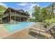 Beautiful log cabin home featuring an in-ground pool, sun loungers, hot tub, and upper and lower patios at 9600 N 500 E, Pendleton, IN 46064
