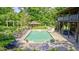 Backyard with a large in-ground pool, lounge chairs, and surrounding lush greenery at 9600 N 500 E, Pendleton, IN 46064