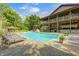 In-ground pool surrounded by lounge chairs, mature trees, and a charming gazebo for outdoor living at 9600 N 500 E, Pendleton, IN 46064
