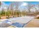 Winter view of a large pool with a pool cover, surrounded by lounge chairs and a gazebo at 9600 N 500 E, Pendleton, IN 46064