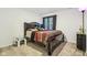 Cozy bedroom with dark wood bed frame and carpet at 1075 Galaxy Ln, Danville, IN 46122