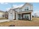 Two-story home with gray siding, brick accents, and a landscaped yard at 1075 Galaxy Ln, Danville, IN 46122
