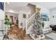 Living room with Christmas tree, hardwood floors, and a view of the staircase at 1075 Galaxy Ln, Danville, IN 46122