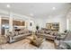 Open floor plan living room with large sofas, coffee table, and kitchen view at 1075 Galaxy Ln, Danville, IN 46122