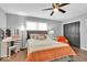 Spacious bedroom with orange bedding and a ceiling fan at 11726 E 75Th St, Indianapolis, IN 46236