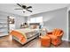Comfortable bedroom featuring an orange accent chair and a ceiling fan at 11726 E 75Th St, Indianapolis, IN 46236