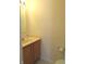 Simple half-bath with a wood vanity and sink, perfect for guests' convenience at 1217 Legacy Ln, Indianapolis, IN 46234
