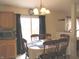 Cozy dining area with a table set for six, bathed in natural light, adjacent to the kitchen at 1217 Legacy Ln, Indianapolis, IN 46234