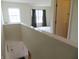 Hallway with railing and view to bedroom with curtains at 1217 Legacy Ln, Indianapolis, IN 46234