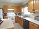 Bright kitchen with oak cabinets, white appliances, and stainless steel sink at 1217 Legacy Ln, Indianapolis, IN 46234