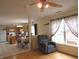 Open living room with view of the kitchen, hardwood floors, and ample natural light at 1217 Legacy Ln, Indianapolis, IN 46234