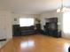 Spacious living room with hardwood floors, offering a comfortable and versatile space for relaxation and entertainment at 1217 Legacy Ln, Indianapolis, IN 46234