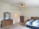Spacious main bedroom featuring carpeted floors, ceiling fan, and large dressers at 1217 Legacy Ln, Indianapolis, IN 46234