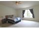 Large bedroom with ceiling fan, carpet, and ample natural light at 1217 Legacy Ln, Indianapolis, IN 46234