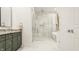 Spa-like bathroom with walk-in shower, soaking tub, and marble floors at 1561 N Park Ave, Indianapolis, IN 46202