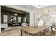 Open concept dining room with a wooden table, view into Gathering room and kitchen at 1561 N Park Ave, Indianapolis, IN 46202