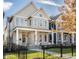 Two-story house with gray siding, black fence, and landscaped lawn at 1561 N Park Ave, Indianapolis, IN 46202