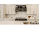 Modern kitchen features a black range hood, marble countertops, and custom cabinetry at 1561 N Park Ave, Indianapolis, IN 46202