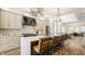 Modern kitchen with light cabinets, marble island, stainless steel appliances, and hardwood floors at 1561 N Park Ave, Indianapolis, IN 46202
