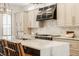 Modern kitchen features a black range hood, marble countertops, and custom cabinetry at 1561 N Park Ave, Indianapolis, IN 46202