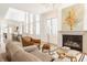 Living room with fireplace, chandelier, and view to kitchen at 1561 N Park Ave, Indianapolis, IN 46202