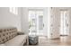 Light and airy sitting area with a comfortable couch and French doors at 1561 N Park Ave, Indianapolis, IN 46202