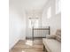 Elegant upstairs hall with light hardwood floors and a chandelier at 1561 N Park Ave, Indianapolis, IN 46202