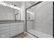 Modern bathroom featuring a glass-enclosed shower and a double sink vanity with gray countertops at 16956 Cattle Hollow Ln, Noblesville, IN 46060
