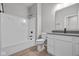 A well lit bathroom features a shower-tub and vanity with wood look flooring at 16956 Cattle Hollow Ln, Noblesville, IN 46060