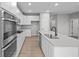 Modern kitchen featuring stainless steel appliances, ample white cabinetry, and a stylish island with a sink at 16956 Cattle Hollow Ln, Noblesville, IN 46060