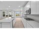 Modern kitchen with stainless steel appliances, sleek countertops, a kitchen island, and ample natural light at 16956 Cattle Hollow Ln, Noblesville, IN 46060