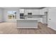Modern kitchen with stainless steel appliances, ample white cabinetry, and a stylish island with a sink at 16956 Cattle Hollow Ln, Noblesville, IN 46060