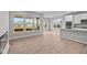 Bright and airy open concept area features recessed lighting, large windows and seamlessly connects the kitchen and living spaces at 16956 Cattle Hollow Ln, Noblesville, IN 46060