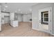 Spacious open-concept living area with luxury vinyl plank flooring and features an adjacent modern kitchen with white cabinetry at 16956 Cattle Hollow Ln, Noblesville, IN 46060