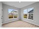 Living room featuring light wood flooring, a view of the backyard from the windows, and white trim at 16956 Cattle Hollow Ln, Noblesville, IN 46060