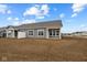 New construction home showcasing a spacious backyard and gray exterior with white trim at 16964 Cattle Hollow Ln, Noblesville, IN 46060