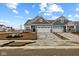 Beautiful townhome with a two-car garage, gray siding, stone accents, and professionally landscaped front yard at 16964 Cattle Hollow Ln, Noblesville, IN 46060
