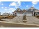 Attractive townhome with gray siding, stone accents, two-car garage, and professionally landscaped front yard at 16964 Cattle Hollow Ln, Noblesville, IN 46060