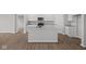 New kitchen features island, white cabinets, and stainless steel appliances, perfect for cooking and entertaining at 16964 Cattle Hollow Ln, Noblesville, IN 46060