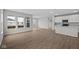 Open-concept living room showcases lots of windows, flowing seamlessly into the modern kitchen and dining area at 16964 Cattle Hollow Ln, Noblesville, IN 46060