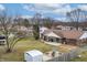 Aerial view of the property, showcasing the backyard with fire pit, deck, sheds, and surrounding neighborhood at 2338 Malibu Ct, Anderson, IN 46012