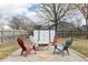 Backyard fire pit with Adirondack chairs, perfect for cozy evenings and outdoor gatherings at 2338 Malibu Ct, Anderson, IN 46012