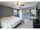 Relaxing bedroom with neutral carpet, a ceiling fan, and a doorway leading to the living area at 2338 Malibu Ct, Anderson, IN 46012