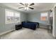Carpeted bedroom with ceiling fan, two windows with blinds, and neutral paint at 2338 Malibu Ct, Anderson, IN 46012