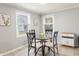 Eat-in kitchen area with a glass table and seating for four and two large windows at 2338 Malibu Ct, Anderson, IN 46012