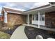 Inviting front porch with brick accents and landscaped garden beds at 2338 Malibu Ct, Anderson, IN 46012