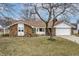 Charming brick home with a well-maintained lawn and mature trees at 2338 Malibu Ct, Anderson, IN 46012